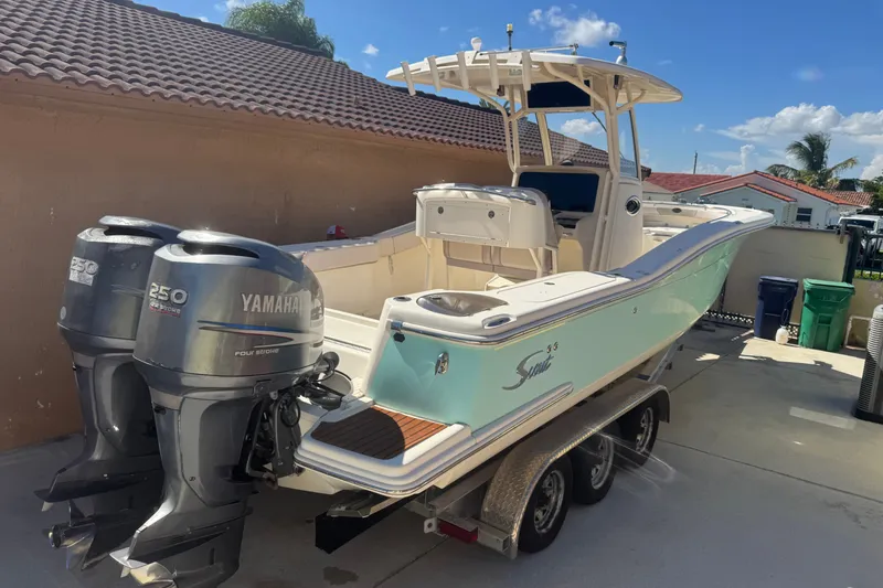 Slide: The Image of 2008 Scout 282 Sportfish boat with twin Yamaha 250 engines on a trailer. - 2