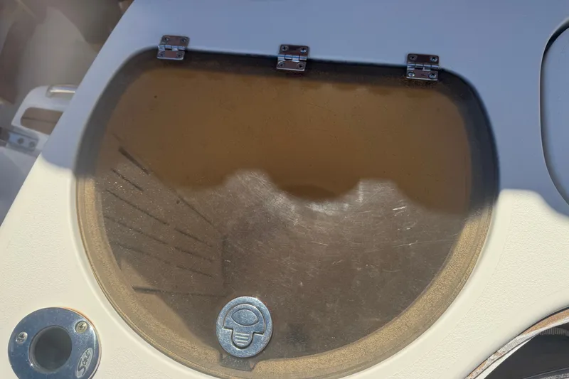 Slide: The Image of 2008 Scout 282 Sportfish boat compartment with transparent cover and metal hinges. - 15