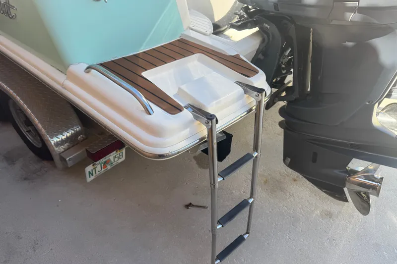 Slide: The Image of Rear view of 2008 Scout 282 Sportfish boat with ladder and motor. - 21