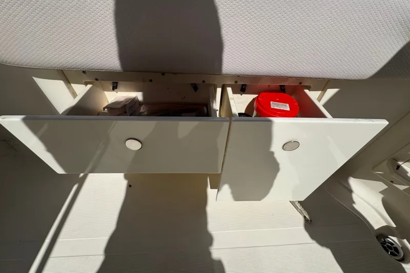 Slide: The Image of Open storage compartments on a 2008 Scout 282 Sportfish boat interior. - 64