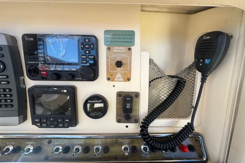 Slide: The Image of Control panel of a 2008 Scout 282 Sportfish boat with communication devices and switches. - 51