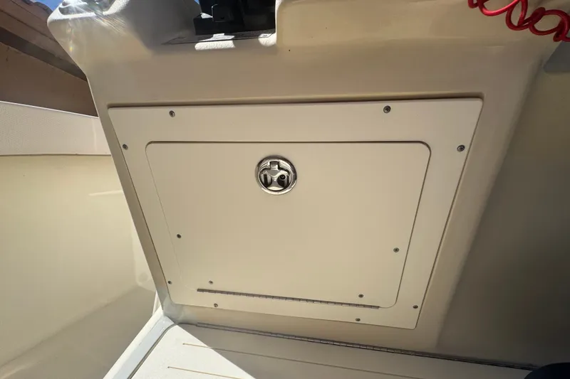 Slide: The Image of Storage compartment on a 2008 Scout 282 Sportfish boat, featuring a secure latch. - 42