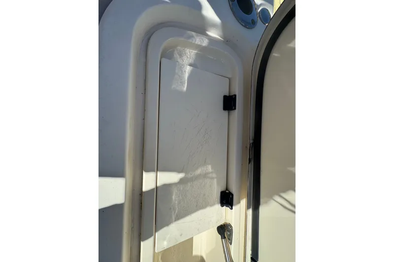 Slide: The Image of Hatch door on a 2008 Scout 282 Sportfish boat, showing wear and sunlight. - 68