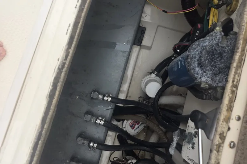 Slide: The Image of Engine compartment of a 2008 Scout 282 Sportfish boat showing hoses and components. - 11