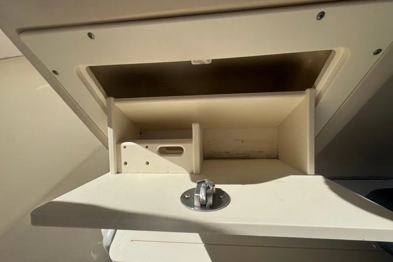 Slide: The Image of Storage compartment on a 2008 Scout 282 Sportfish boat, featuring a latch and dividers. - 41