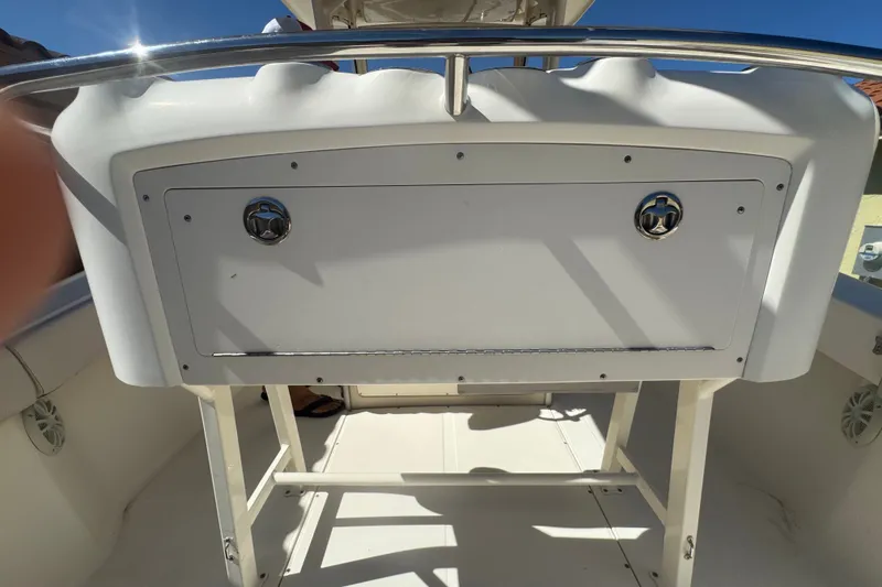 Slide: The Image of 2008 Scout 282 Sportfish boat interior with storage compartment and stainless steel railing. - 58