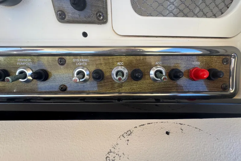 Slide: The Image of Control panel of a 2008 Scout 282 Sportfish boat with labeled switches. - 48
