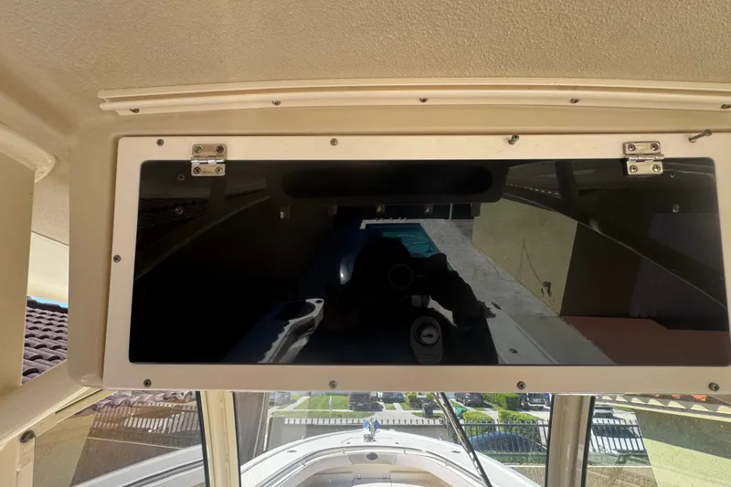 Slide: The Image of 2008 Scout 282 Sportfish boat dashboard with reflective glass panel and exterior view. - 54