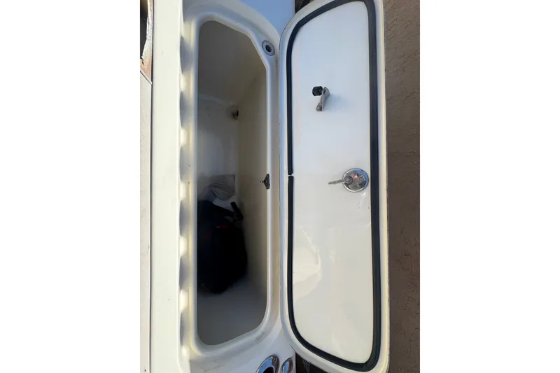 Slide: The Image of Storage compartment of a 2008 Scout 282 Sportfish boat, open with visible latch. - 65