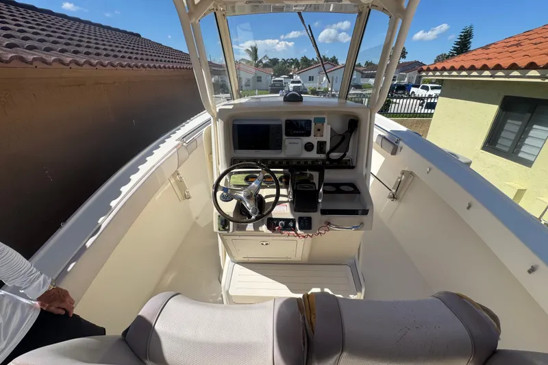 Slide: The Image of 2008 Scout 282 Sportfish boat cockpit with steering wheel and control panel. - 20