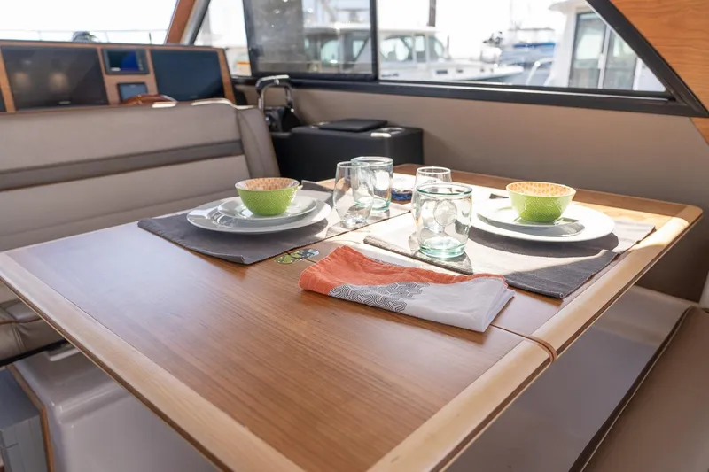 Slide: The Image of Interior dining area of 2027 Cutwater C-32 CB yacht with table setting. - 25
