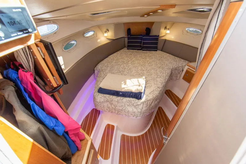 Slide: The Image of Cozy cabin interior of 2027 Cutwater C-32 CB with bed and storage space. - 27