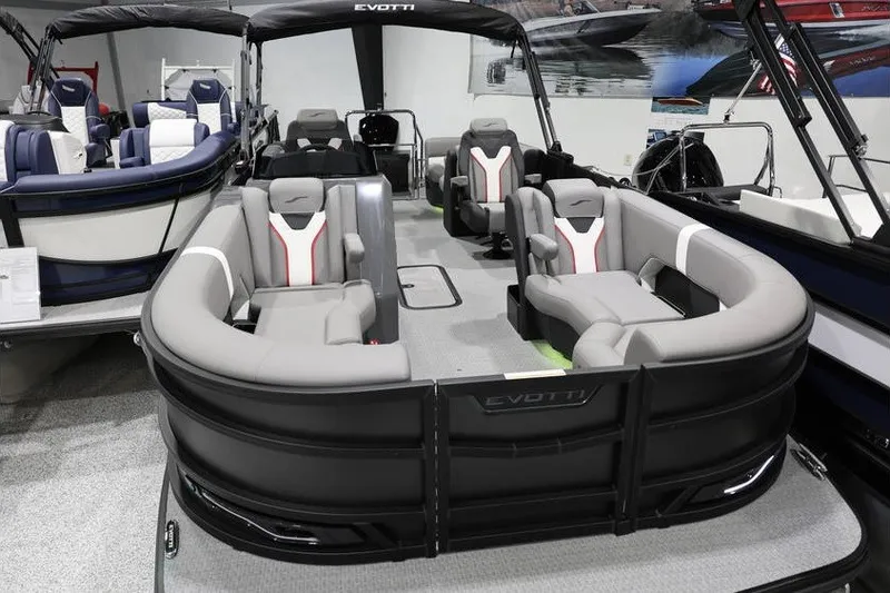 Slide: The Image of 2026 Evotti 721QL pontoon boat with modern seating and sleek design in showroom. - 3