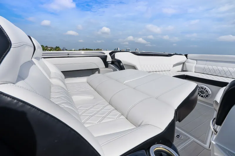 Slide: The Image of Luxurious seating on 2024 Nor-Tech 450 Sport boat under a clear blue sky. - 38
