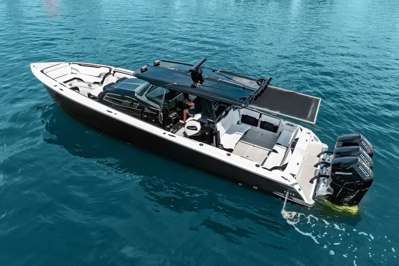 Slide: The Image of 2024 Nor-Tech 450 Sport boat on clear blue water, featuring powerful Mercury engines. - 4