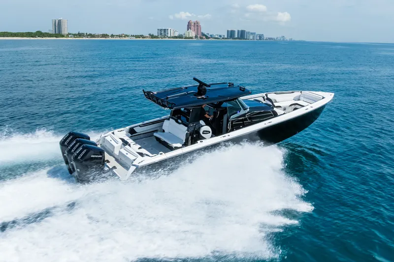 Slide: The Image of 2024 Nor-Tech 450 Sport boat cruising on open water, showcasing sleek design and powerful engines. - 18