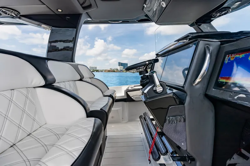 Slide: The Image of Luxurious interior of 2024 Nor-Tech 450 Sport boat with modern dashboard and seating. - 65