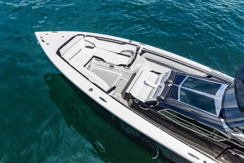 Slide: The Image of 2024 Nor-Tech 450 Sport boat with sleek design on clear blue water. - 6