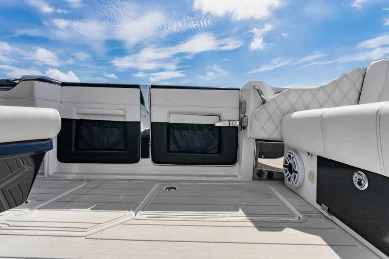 Slide: The Image of 2024 Nor-Tech 450 Sport boat interior with luxurious seating and modern design under blue sky. - 52