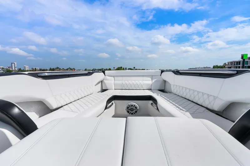 Slide: The Image of Luxurious seating on 2024 Nor-Tech 450 Sport boat under a clear blue sky. - 37