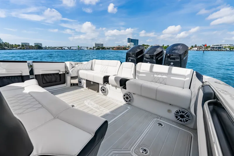 Slide: The Image of 2024 Nor-Tech 450 Sport boat interior with luxurious seating and powerful outboard engines. - 47