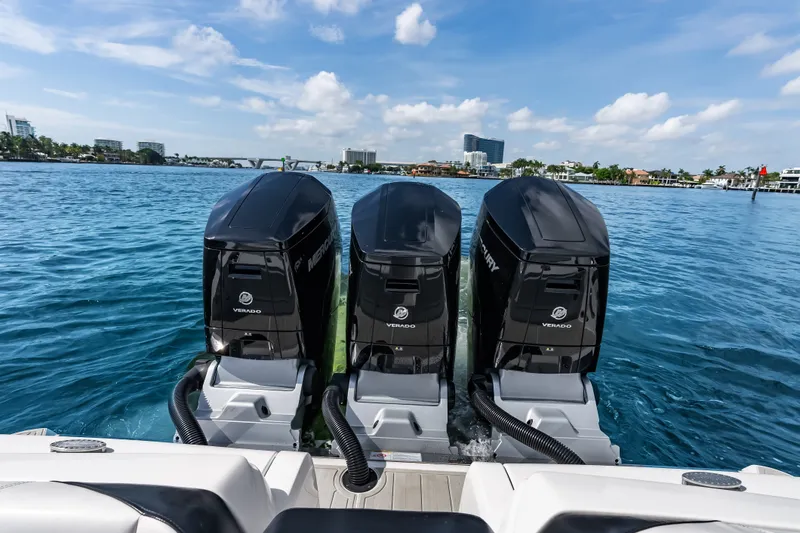 Slide: The Image of 2024 Nor-Tech 450 Sport boat with triple Mercury Verado engines on blue water. - 49