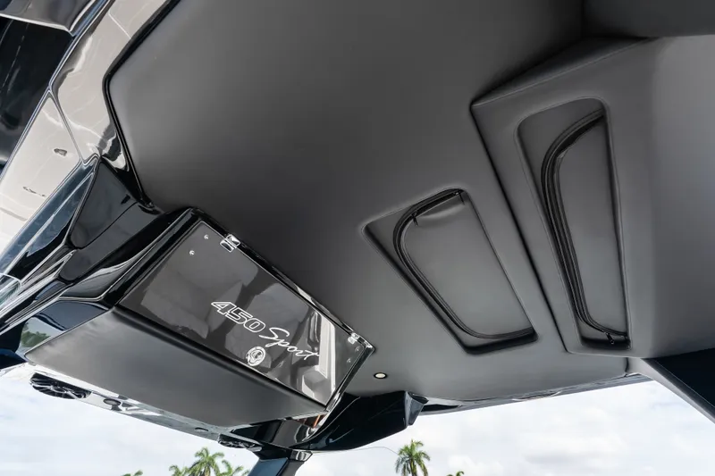 Slide: The Image of 2024 Nor-Tech 450 Sport boat interior ceiling with sleek design and storage compartments. - 68