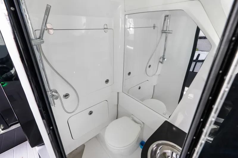 Slide: The Image of Luxurious bathroom interior of 2024 Nor-Tech 450 Sport boat, featuring modern fixtures and sleek design. - 32