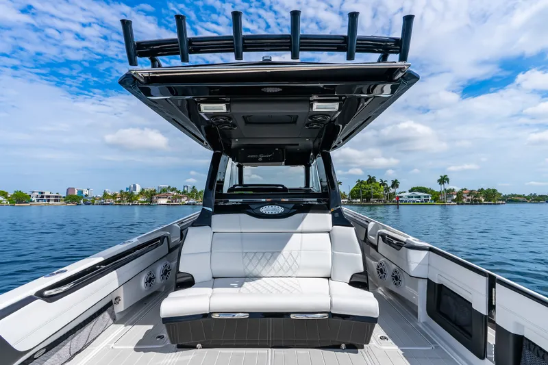 Slide: The Image of 2024 Nor-Tech 450 Sport boat interior with luxurious seating on a sunny day. - 55