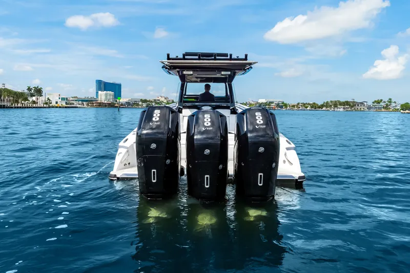 Slide: The Image of 2024 Nor-Tech 450 Sport boat with powerful engines on a sunny day. - 2