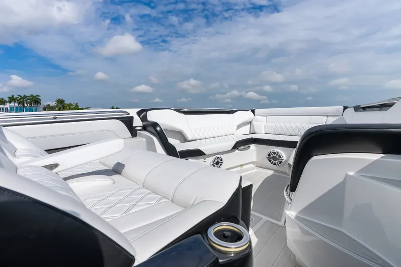 Slide: The Image of Luxurious seating on the 2024 Nor-Tech 450 Sport boat under a clear blue sky. - 36