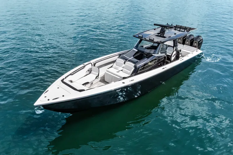 Slide: The Image of 2024 Nor-Tech 450 Sport boat cruising on clear blue water. - 7