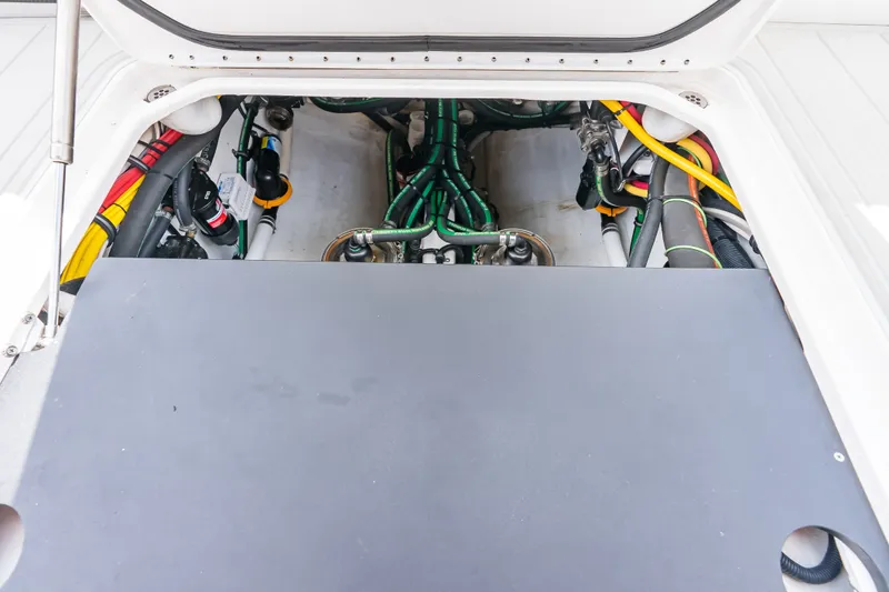 Slide: The Image of Engine compartment of 2024 Nor-Tech 450 Sport boat, showcasing wiring and components. - 59