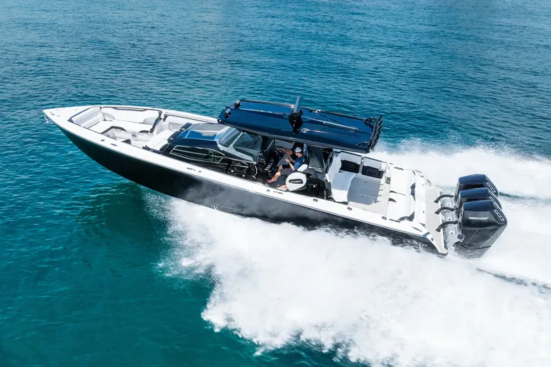 Slide: The Image of 2024 Nor-Tech 450 Sport boat cruising on clear blue water. - 25