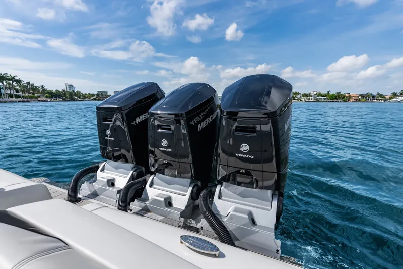 Slide: The Image of 2024 Nor-Tech 450 Sport boat with triple Mercury Verado engines on blue water. - 48
