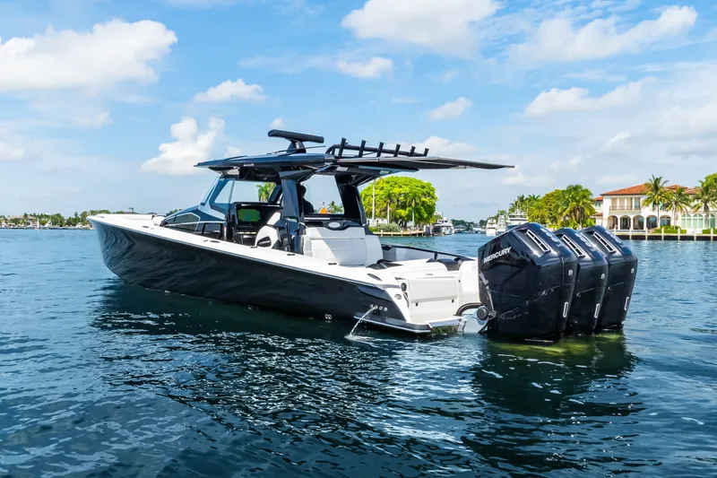 The Image of 2024 Nor-Tech 450 Sport boat with triple Mercury engines on a sunny day. - 0