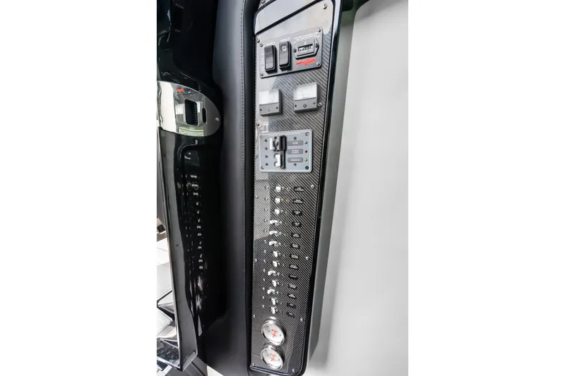 Slide: The Image of 2024 Nor-Tech 450 Sport control panel with sleek carbon fiber design and modern switches. - 27