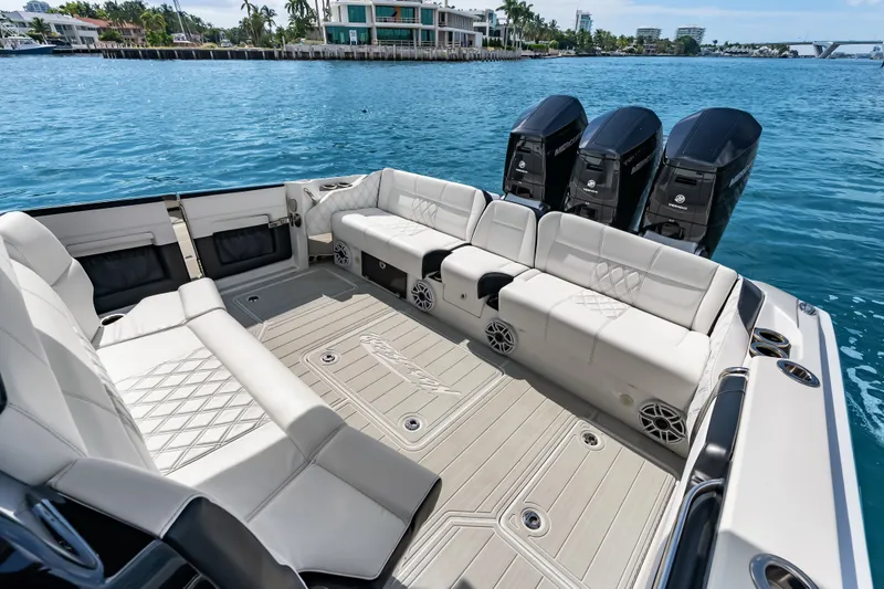 Slide: The Image of 2024 Nor-Tech 450 Sport boat interior with luxurious seating and powerful outboard engines. - 51
