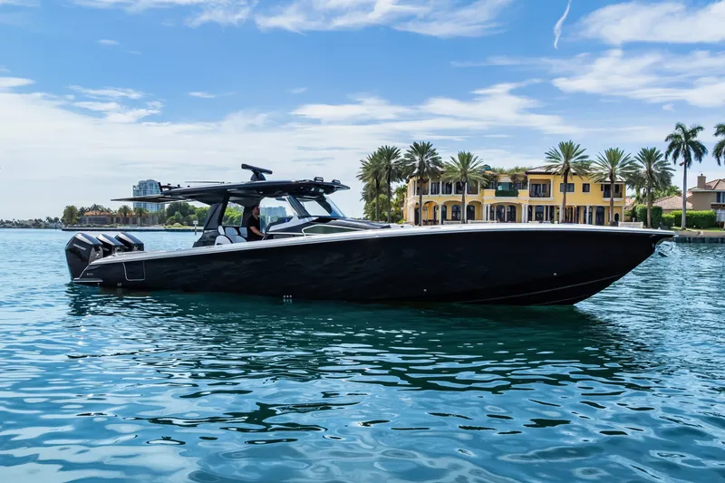 Slide: The Image of 2024 Nor-Tech 450 Sport boat on water, luxury waterfront homes in background. - 10