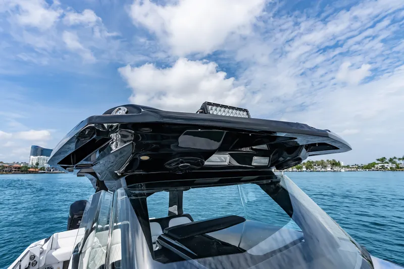 Slide: The Image of 2024 Nor-Tech 450 Sport boat with sleek design on a sunny day at sea. - 45