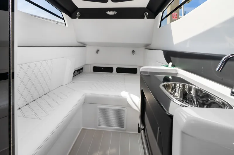 Slide: The Image of Luxurious interior of 2024 Nor-Tech 450 Sport boat with seating and sink. - 28