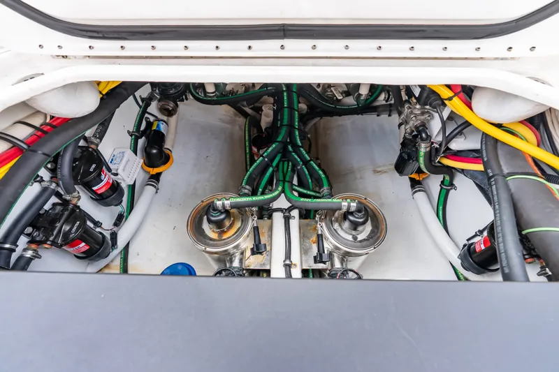 Slide: The Image of Engine compartment of 2024 Nor-Tech 450 Sport boat, showcasing intricate wiring and components. - 60