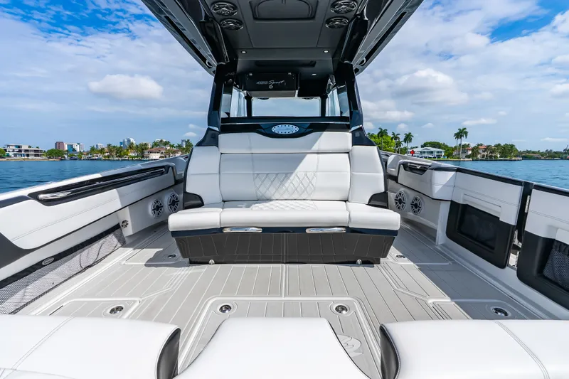 Slide: The Image of 2024 Nor-Tech 450 Sport boat interior with luxurious seating and scenic waterfront view. - 56