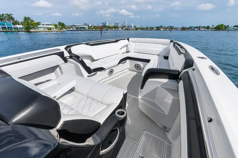 Slide: The Image of Luxurious interior of 2024 Nor-Tech 450 Sport boat with white seating and waterfront view. - 35