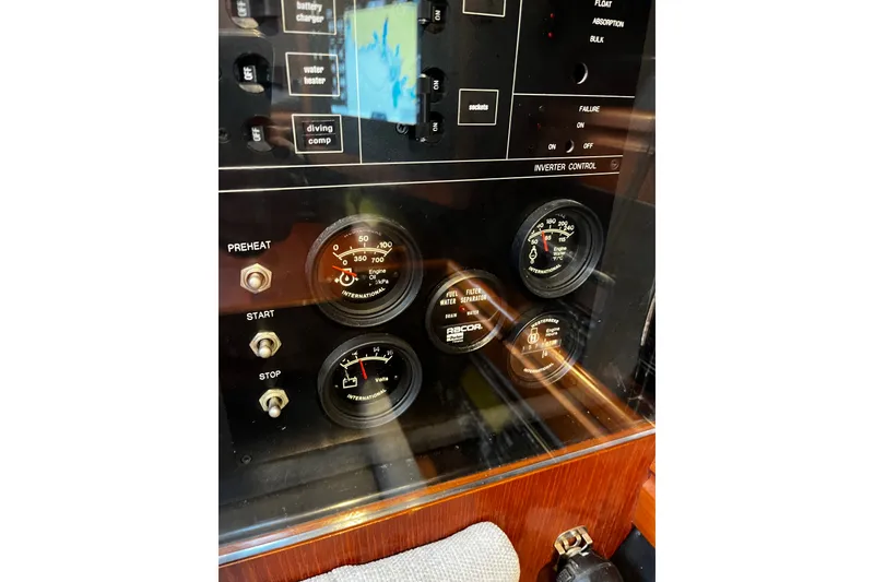 Slide: The Image of Control panel of a 1999 Oyster 53 Deck Saloon yacht with gauges and switches. - 54