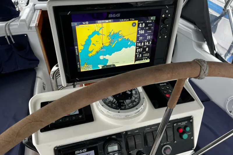 Slide: The Image of Cockpit of 1999 Oyster 53 Deck Saloon with navigation equipment and steering wheel. - 79