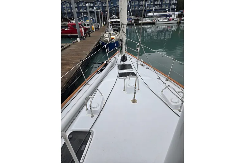 Slide: The Image of Deck view of a 1999 Oyster 53 Deck Saloon yacht docked at a marina. - 65