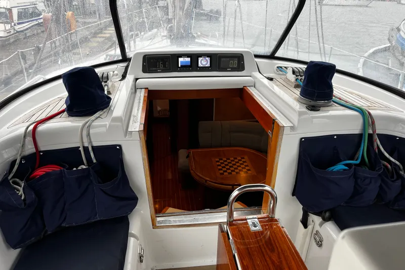 Slide: The Image of Cockpit view of 1999 Oyster 53 Deck Saloon yacht with interior seating and chessboard table. - 75