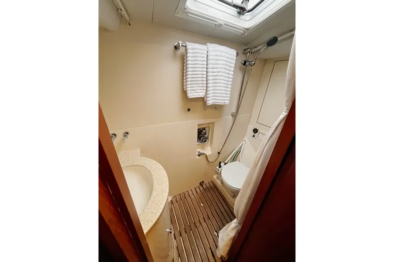 Slide: The Image of Bathroom interior of 1999 Oyster 53 Deck Saloon yacht with shower and wooden floor. - 4