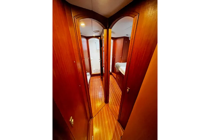 Slide: The Image of Interior hallway of 1999 Oyster 53 Deck Saloon yacht with wooden finish. - 9